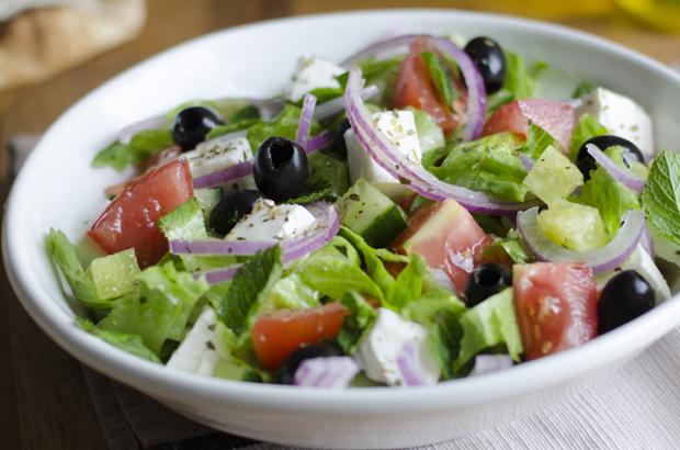 Classic chopped salad with lettuce, olives, tomatoes, feta, red onions
