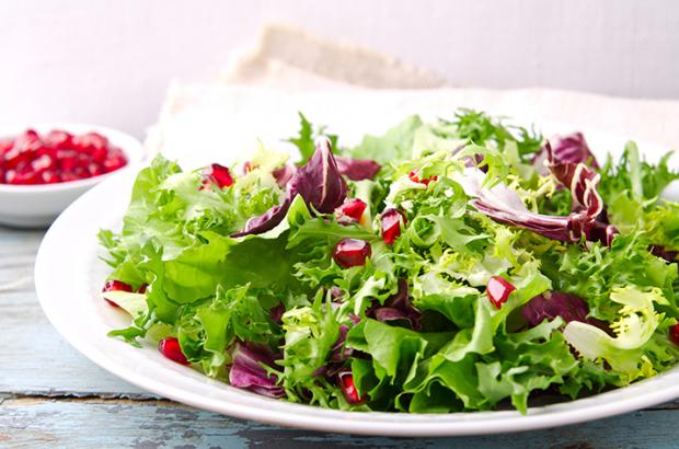 Salad with different lettuce varieties:  frisee, arugula, radicchio