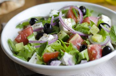Classic chopped salad with lettuce, olives, tomatoes, feta, red onions