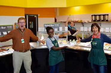 Four enthusiastic employees at a food co-op. Co-op Values and Principles