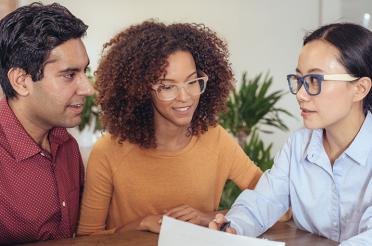 Couple reviewing their finances with a credit union financial advisor