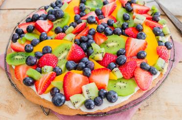 Shortbread fruit pizza topped with colorful sliced fruit