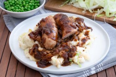 Irish Bangers and Mash - sausages with onion gravy and mashed potatoes with cabbage
