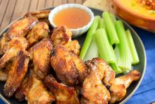 Chicken wings on a plate with celery sticks