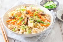 Bowl of brown rice with egg roll toppings